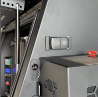 Closed Flip Pro Multi socket installed in a black vehicle canopy power panel