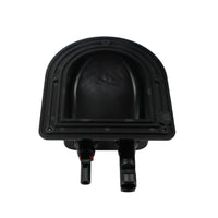 Underside of black plastic housing showing internal cavity and mounting flange
