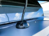 Close-up of a black cable seal installed on a van roof routing a heavy-duty black cable