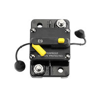 Top-down view of circuit breaker with protective caps removed revealing stainless steel studs