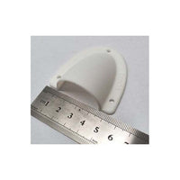 Front perspective of white clamshell cable cover with ruler showing width