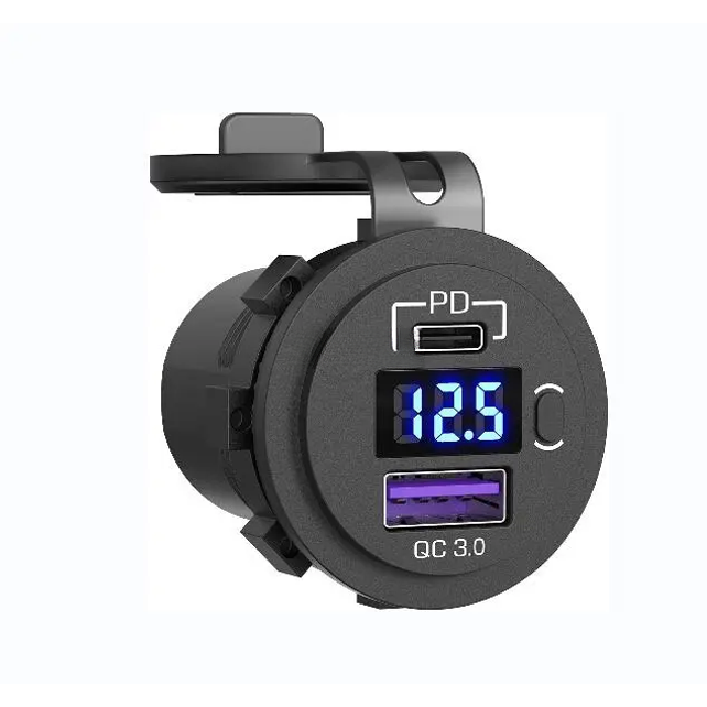 Angled view of black socket showing USB-C PD port, blue digital voltmeter, power button and QC 3.0 USB-A port