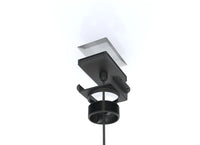 Exploded view showing wireless charger unit, mounting bracket, and compression puck components