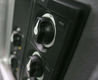 Angled close-up of battery switch mounted on dark control panel showing knob profile
