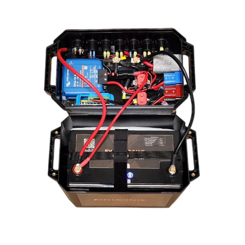 Open battery box lid revealing internal wiring, Victron Orion XS charger and circuit protection