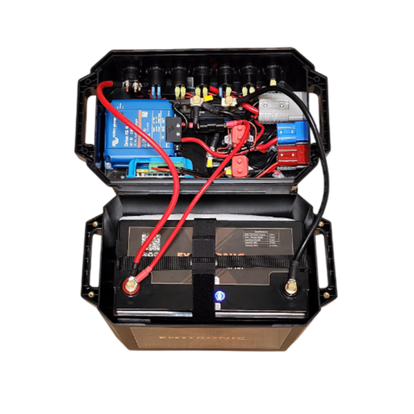 Open battery box lid revealing internal wiring, Victron Orion XS charger and circuit protection