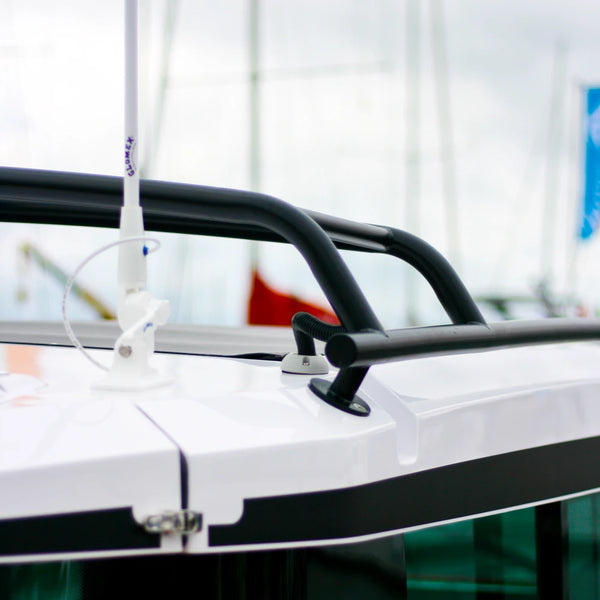 Marine antenna cable passing through a light grey vertical seal on a boat cabin roof