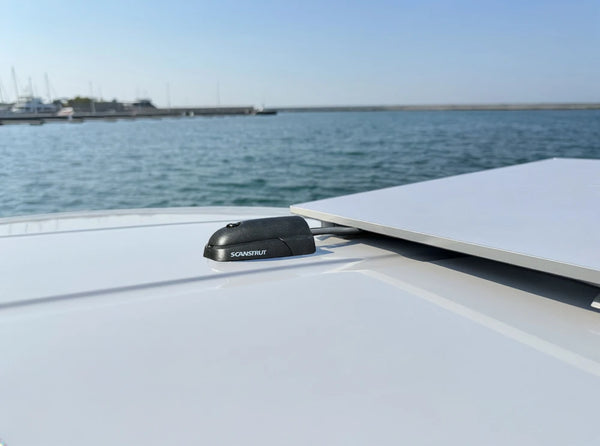 Marine cable seal installed on a white deck in a coastal environment