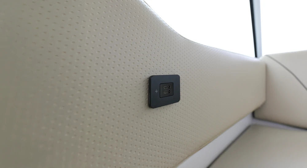 USB-C socket installed on a cream textured marine interior wall panel