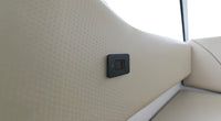 USB-C socket installed on a cream textured marine interior wall panel