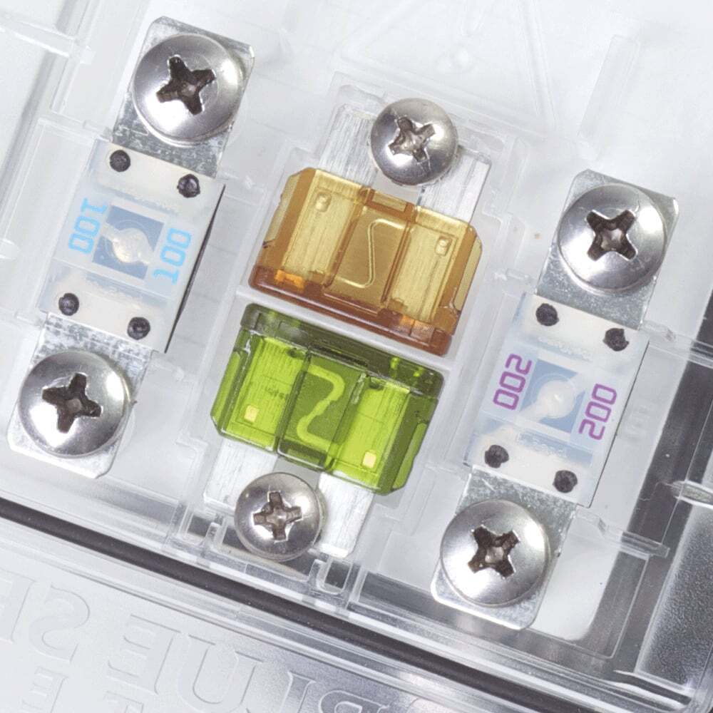 Close-up of ATO/ATC fuse sockets with installed fuses and spare puller tool