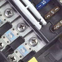 Macro view of MIDI/AMI high-amperage fuses secured with screws