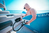 Man inflating a blue paddleboard using the Scanstrut ATMOS station installed on a boat deck
