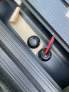 Overhead view of the installation process for Scanstrut cable seals on a black surface