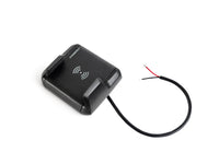 Angled view of Nano wireless charger showing integrated 12/24V power cable