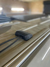 Side view of a horizontal multi cable seal mounted on a ribbed vehicle roof