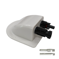 Angled view of white solar cable entry cover with integrated black connectors and loose crimp terminals