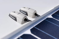 Two horizontal cable seals managing solar panel wiring on a roof