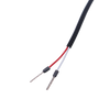 Close-up of red and white wire leads with stripped ends for connection
