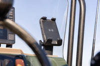 Wireless phone charger mounted on a vehicle dashboard for outdoor use
