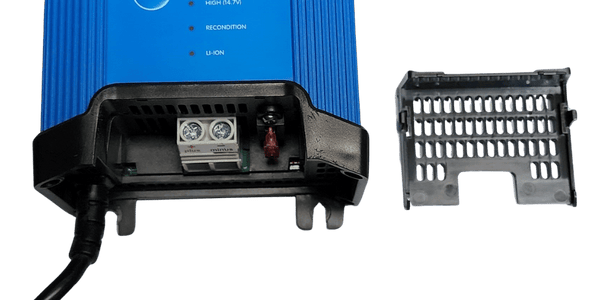 Close-up of charger screw terminals and replaceable fuse with cover removed