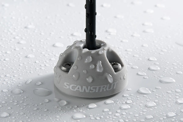 Close-up of light grey Scanstrut cable seal with water droplets demonstrating IP rating