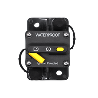 Top-down view of 80A waterproof circuit breaker with yellow reset lever and protective caps