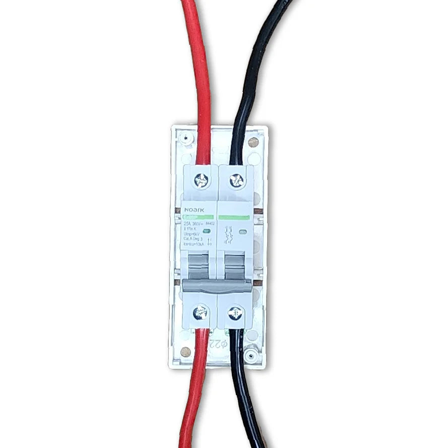 Top-down view of DC circuit breaker with red and black cables connected to bottom terminals