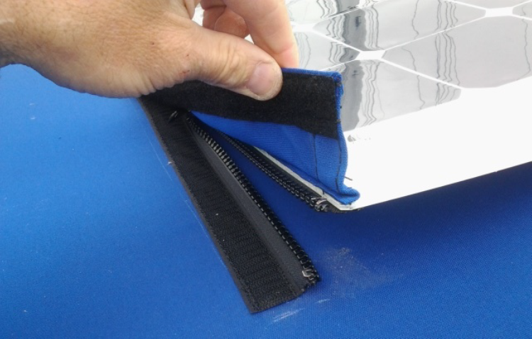 Zippers attached to a flexible solar panel