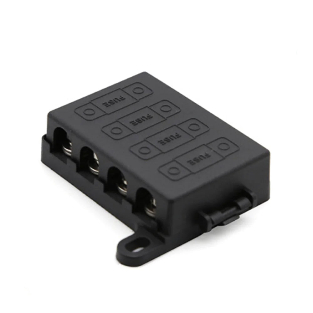Angled view of black 4-way midi fuse holder with protective cover and mounting tabs