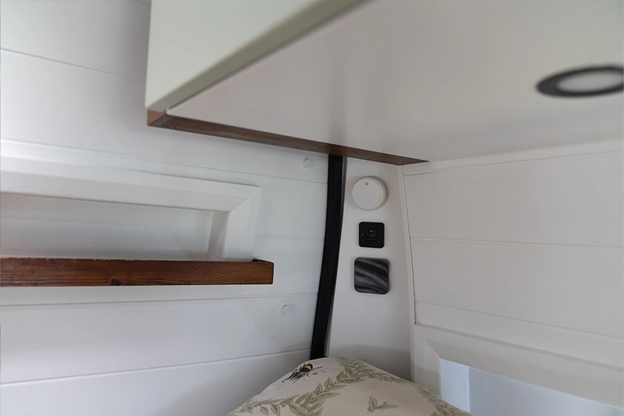 Flush mounted wireless charger on a white vertical camper wall