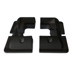 Four black ABS plastic solar panel corner brackets showing aerodynamic profile and internal mounting recesses