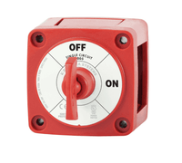 Angled view of red marine battery switch with removable key selector in OFF position and visible side knockouts