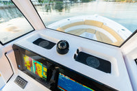 Marine dashboard featuring flush-mounted wireless phone chargers near GPS screens