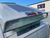 Grey van roof with a solar panel and two black cable seals routing wires through the roof