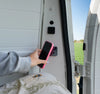 Magnetic wireless charger installed in a camper van wall with phone charging
