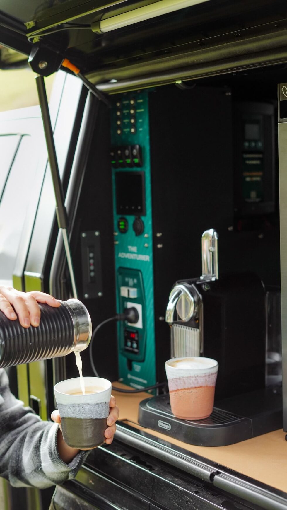 Lifestyle view of coffee being made in a 4x4 canopy using the Adventurer power system