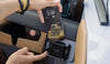 Smartphone mounted vertically in a wireless charger on a modern vehicle dashboard