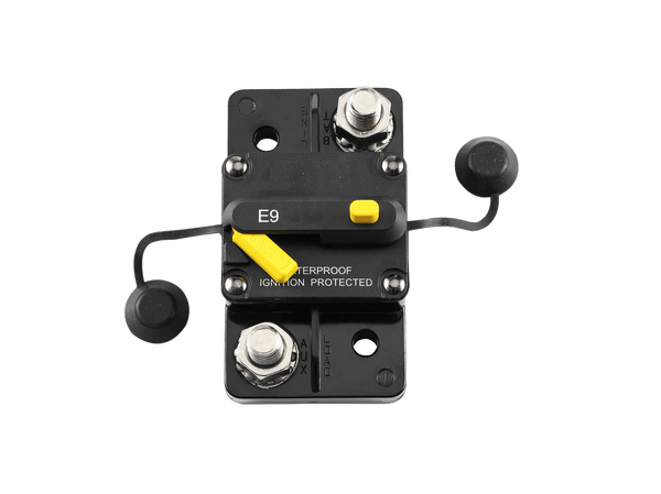 Top view of circuit breaker with protective caps open revealing connection studs