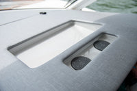 Two wireless chargers installed in a recessed tray on a marine boat helm
