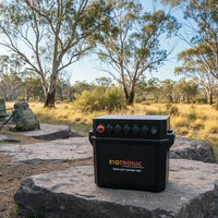 Exotronic 180Ah pre-wired lithium battery box in a camping environment with eucalyptus trees