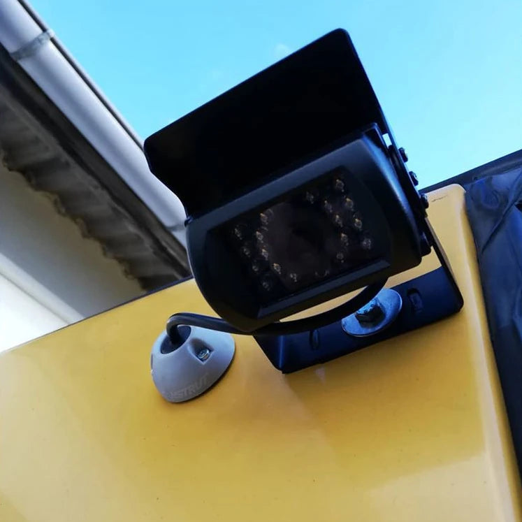 Grey Scanstrut cable seal used for camera wiring on a yellow vehicle exterior