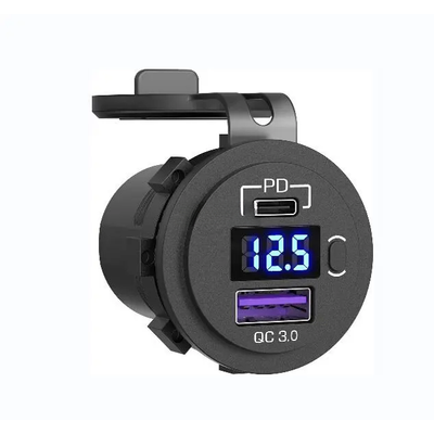 Angled view of black socket showing USB-C PD port, blue digital voltmeter, power button and QC 3.0 USB-A port