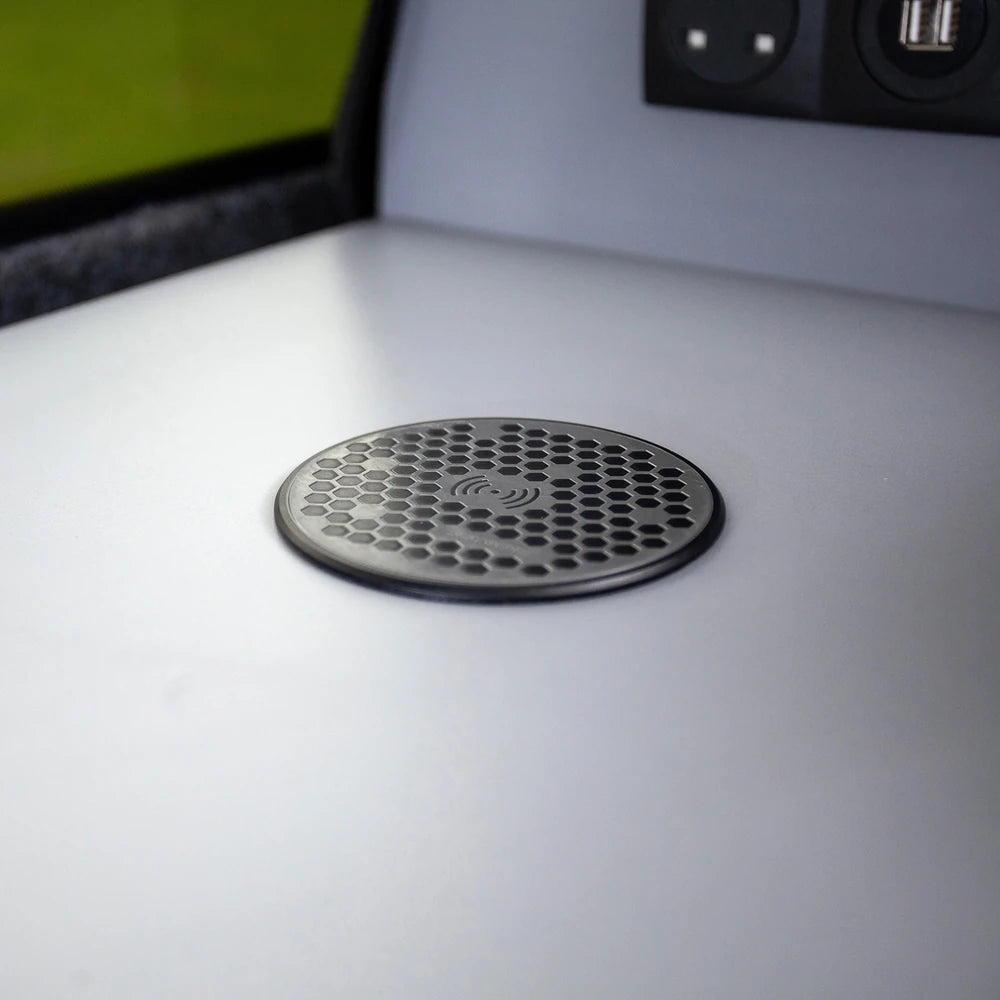 Low-profile flush-mounted wireless charger on a light grey dashboard