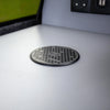 Low-profile flush-mounted wireless charger on a light grey dashboard