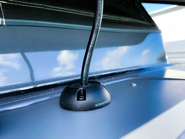 Black cable seal installed on a grey campervan roof with cable