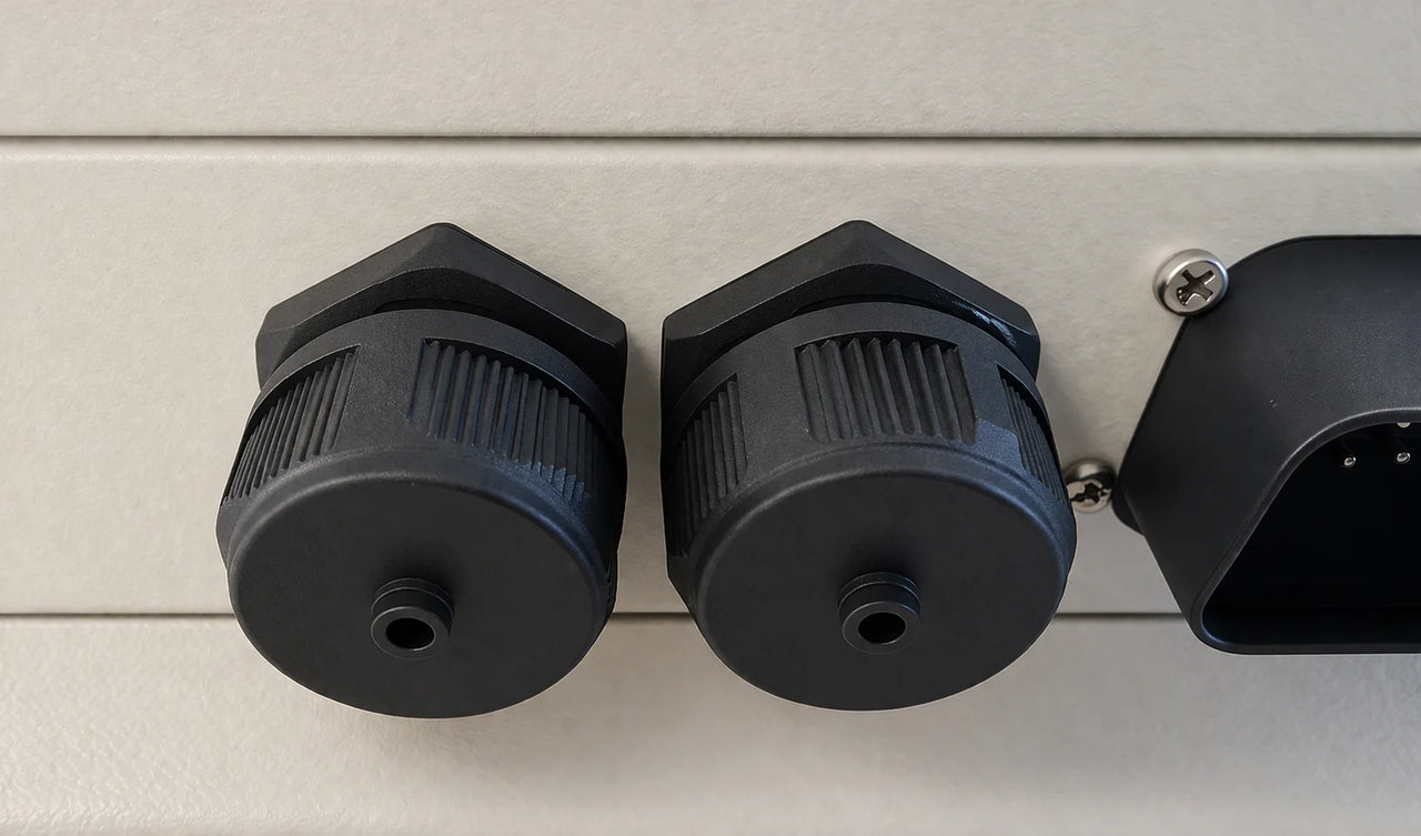 Close-up of black waterproof caps installed on a Wakespeed WS500 regulator housing