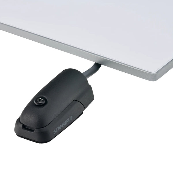 Black horizontal cable seal installed on a flat white mounting surface with a grey cable entry