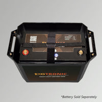 Top-down view into battery box showing heavy-duty strap securing the battery unit