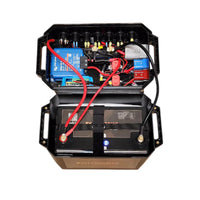 Open battery box lid revealing internal wiring, Victron Orion XS charger and circuit protection
